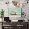 Pew Pew playful military tank art print displayed in industrial home office with concrete walls, vintage pop art wall decor for modern workspace design and creative studio interior styling